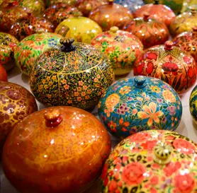 Assorted colorful papier-mâché handicraft boxes with intricate floral designs – Indian art from Kaarigar